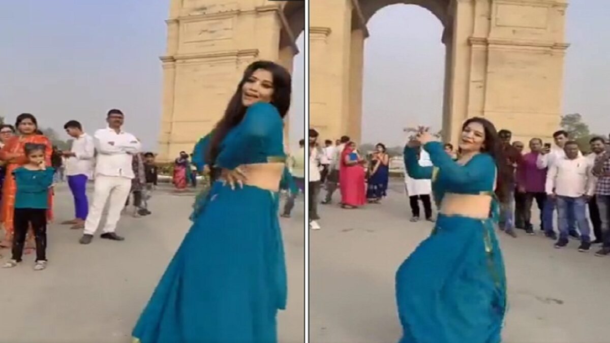 Girl dances in front of India Gate