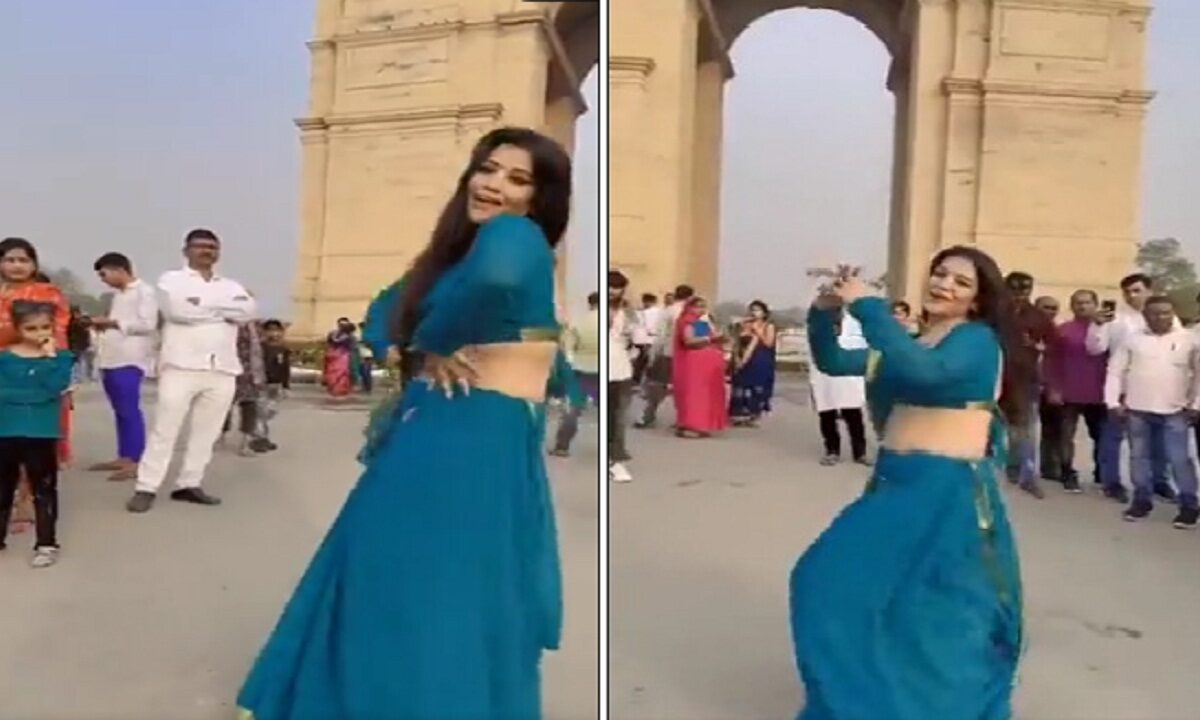 Girl dances in front of India Gate