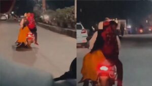man kissing woman on scooter