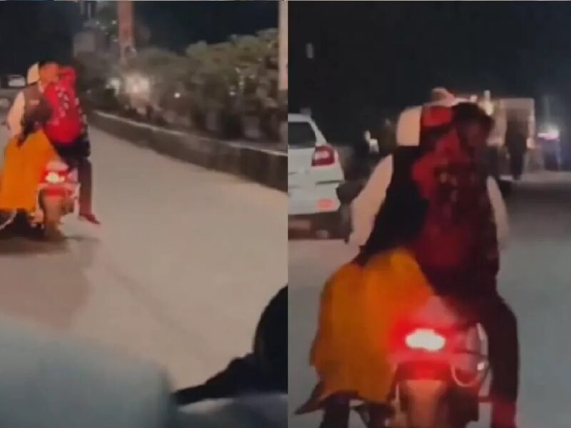 man kissing woman on scooter